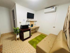 a living room with a couch and a tv at Alanta aonang resort in Ban Khlong Haeng +38 photos