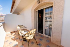 a balcony with two chairs and a table at Rooms by JovA in El Campello