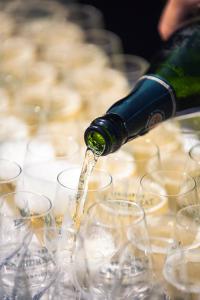 a bottle of wine is being poured into wine glasses at Risinge Herregård Bed & Breakfast in Ullerslev +43 photos