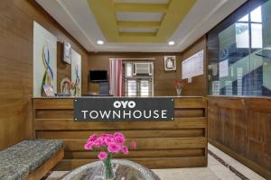 a vase of flowers on a table in a room at Capital O Jayam Residency in Chennai +28 photos