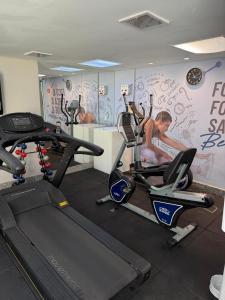 a gym with two exercise bikes and a wall with graffiti at Savassi Tower Cobertura in Belo Horizonte