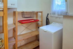 a kitchen with wooden shelves and a washing machine at PORTOVECCHIO Extra in Levanto +71 photos