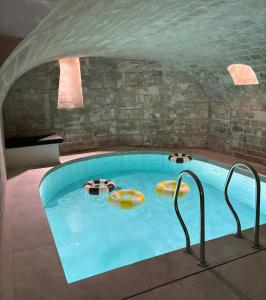 a swimming pool with two chairs in a room at Madame Drouot & Spa - Opera in Paris