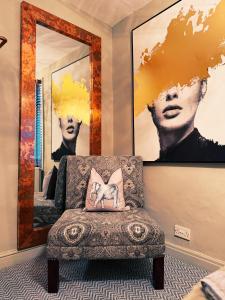 a room with a chair and a mirror at Rose Cottage in Whitby