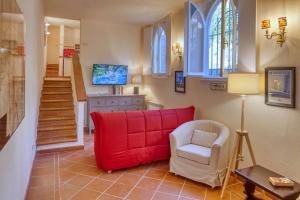 a living room with a red couch and a chair at PORTOVECCHIO Extra in Levanto