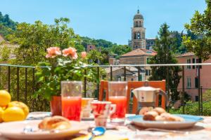 a table with food and drinks on a balcony at PORTOVECCHIO Extra in Levanto