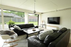 a living room with a couch and a table at Granlunden id089 in Esbjerg