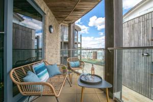 a balcony with wicker chairs and a table at 2 Bed in West Bay oc-wy487 in West Bay