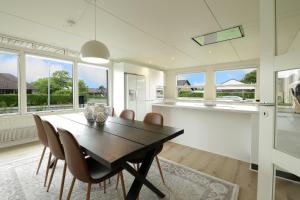 a kitchen and dining room with a table and chairs at Granlunden id089 in Esbjerg