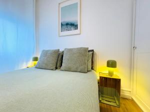 a bedroom with a bed with two pillows on it at Casa Mouzi - Matosinhos in Matosinhos