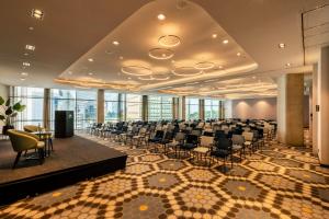 a conference room with chairs and tables in a building at Van der Valk Hotel Amsterdam Zuidas-Rai in Amsterdam