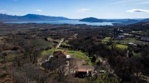 an aerial view of a house on a hill next to a lake at K Ardamis Estate in Kastoria