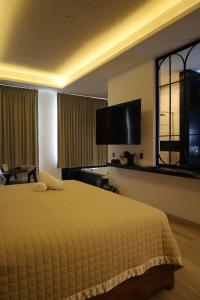 a hotel room with a bed and a large window at Yolihuani Relax Resort in Calvillo