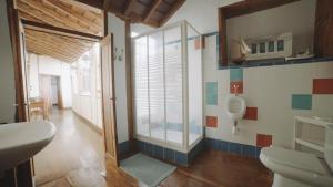 a bathroom with a sink and a urinal on the wall at Casa La Monja in Garachico