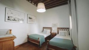 a bedroom with two beds and a piano in it at Casa La Monja in Garachico