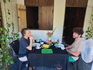 a man and a woman sitting at a table at Venus Inn Goyambokka in Tangalle