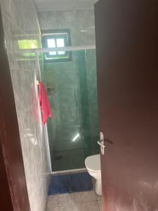 a bathroom with a shower and a toilet at Casa Vidro Mar in Bombinhas +18 photos