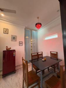 a dining room with a table and chairs at Kozy Cottage udaipur in Udaipur