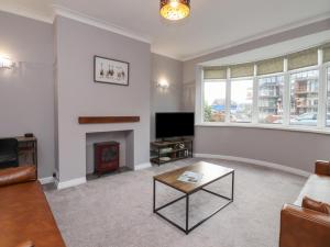 a living room with a couch and a fireplace at Seaside Serenity in Lytham St Annes