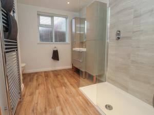 a bathroom with a glass shower and a toilet at Seaside Serenity in Lytham St Annes +18 photos