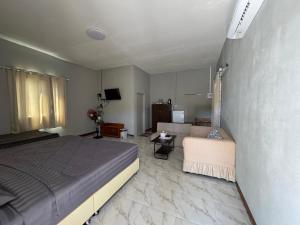 a bedroom with a bed and a living room at Phak Ploen Home Stay in Ban Rae Mai Phai +9 photos