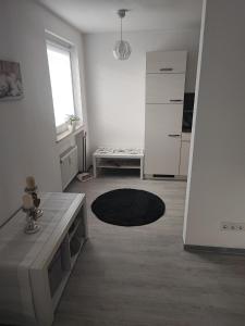 a white living room with a table and a refrigerator at Sweet Home in Hameln +10 photos
