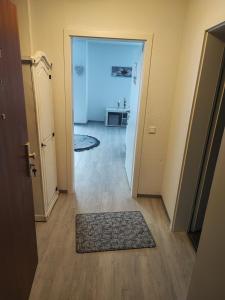 a hallway with a door and a rug on the floor at Sweet Home in Hameln
