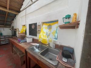 a kitchen with a sink and a wooden counter top at Sunflower Cottage near Ojo de Agua in Las Pilas