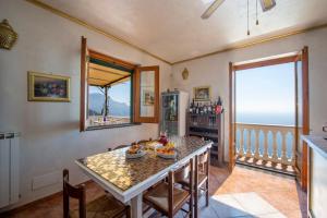 a dining room with a table and a view of the ocean at Villa Gioiello in Amalfi