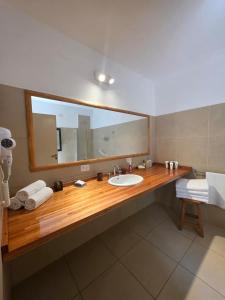 a bathroom with a sink and a large mirror at Hotel Loma Bola in La Paz +29 photos