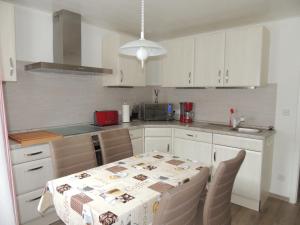 a kitchen with a table with a table cloth on it at Ferienhaus Snevern in Schneverdingen