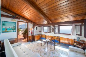 a living room with a couch and a table at Villa Gioiello in Amalfi