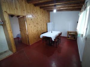 a dining room with a table and chairs in a room at Antonio House in Uspallata