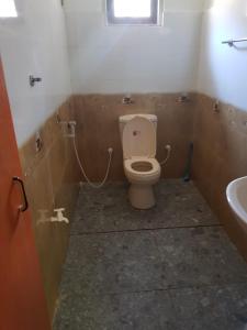 a bathroom with a toilet and a sink at Villa Golden Drift in Ahangama