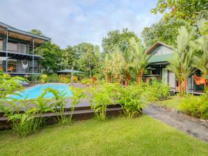 a villa with a swimming pool and a house at Southern Drake Lodge in Drake