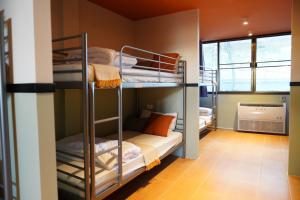 a bunk bed room with bunk beds in it at Nitra Hostel Siriraj in Bangkok