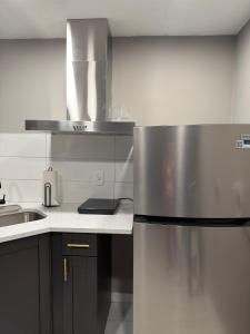 a kitchen with a stainless steel refrigerator and a sink at Nice private room with separate entrance in Port Richey