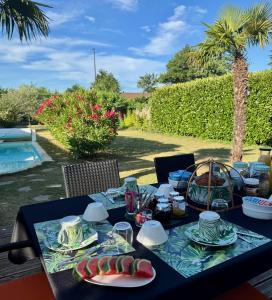 a table with plates of food on top of it at Les Tignoliers in Tignieu-Jameyzieu