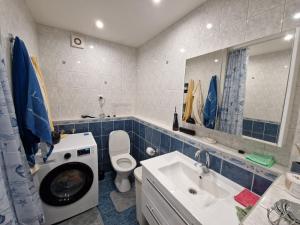 a bathroom with a washing machine and a sink at Sitsi apartment in Tallinn +31 photos