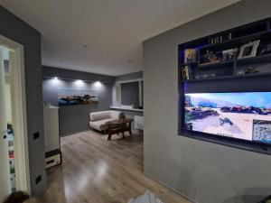 a living room with a flat screen tv on a wall at Sitsi apartment in Tallinn