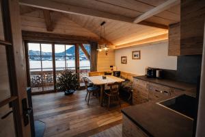 a kitchen with a table and a view of the ocean at Chalet Herbst in Lofer