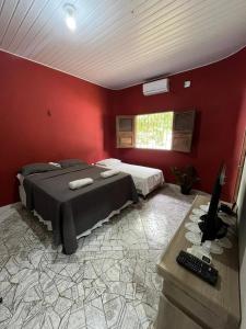 a bedroom with a bed and a desk with a computer at Estação 48 in Castanhal