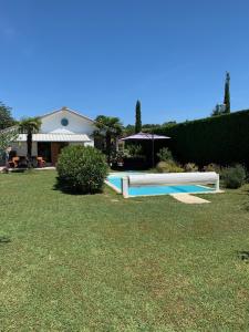 a swimming pool in the yard of a house at Les Tignoliers in Tignieu-Jameyzieu
