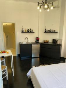 a kitchen with a sink and a counter top at Artelie apartment in Kyparissia