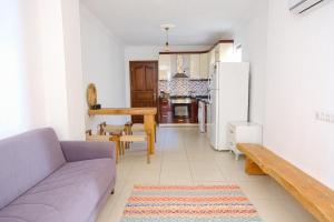 a living room with a couch and a kitchen at The Place Boutique Hotel Kalkan in Kalkan