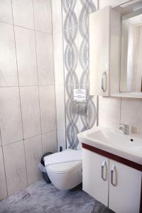 a bathroom with a toilet and a sink at The Place Boutique Hotel Kalkan in Kalkan +43 photos