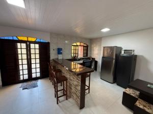 a kitchen with a counter and a refrigerator at Kit net great price in São Sebastião