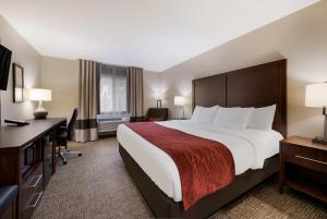 a hotel room with a large bed and a desk at Comfort Inn Onalaska - La Crosse Area in Onalaska +46 photos