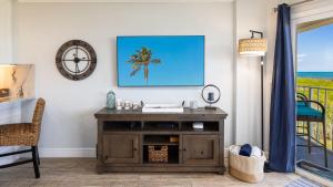 a living room with a tv on a wall at Saltair Loft Ocean Pointe 2 BR 2 BA 1411 in Tavernier