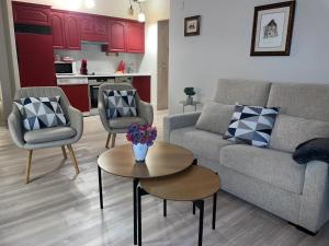 a living room with a couch and two chairs and a table at Apartamento Los Valles in Jaca